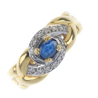 A sapphire and diamond dress ring. The oval-shape sapphire, within a single-cut diamond scrolling su