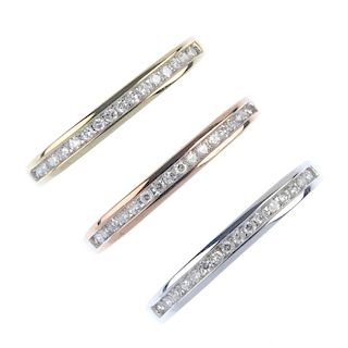 A selection of three 9ct gold diamond half-circle eternity rings. The tri-colour trio of rings, each