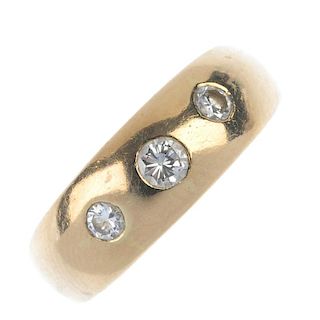 A mid 20th century diamond three-stone ring. The graduated brilliant-cut diamond line, inset to the