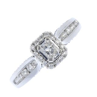 An 18ct gold diamond dress ring. The rectangular-shape diamond, within a brilliant-cut diamond surro