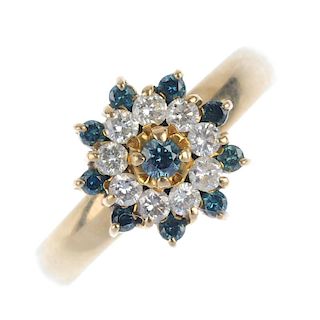 A diamond and colour treated diamond cluster ring. The brilliant-cut colour treated 'blue' diamond,