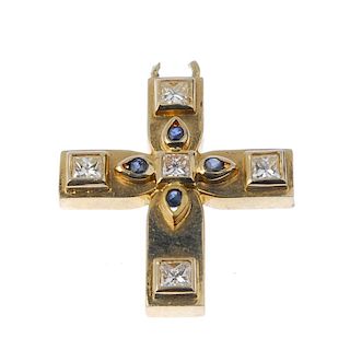A diamond and sapphire cross pendant. The square-shape diamond and circular-shape sapphire floral ce