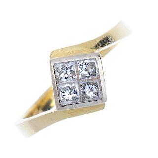 An 18ct gold diamond four-stone ring. The square-shape diamond panel, with crossover shoulders and p