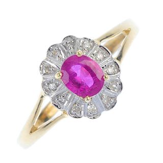A 9ct gold ruby and diamond cluster ring. The oval-shape ruby, within a single-cut diamond scalloped