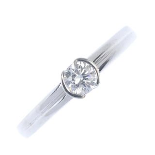 An 18ct gold diamond single-stone ring. The brilliant-cut diamond, within a partial collet mount, to