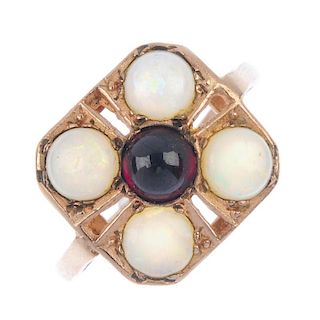 Two 9ct gold gem-set rings. The first designed as a circular garnet cabochon within a circular opal