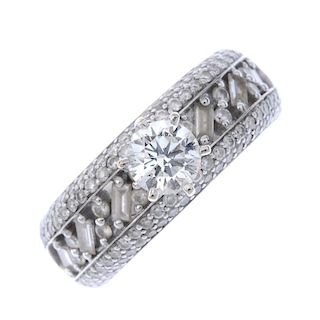 A diamond dress ring. The brilliant-cut diamond, set atop a brilliant and baguette-cut diamond openw