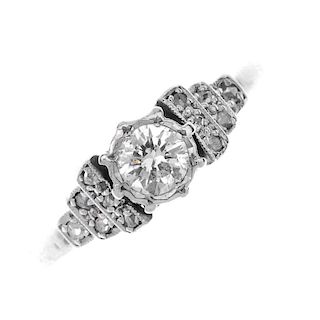A diamond dress ring. The brilliant-cut diamond, with rose-cut diamond stepped shoulders, to the pla