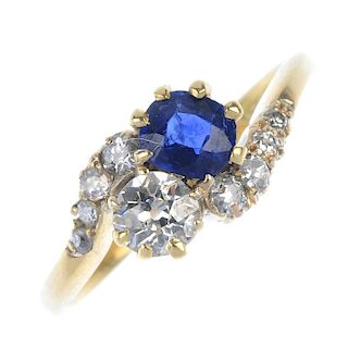 An early 20th century 18ct gold sapphire and diamond two-stone crossover ring. The cushion-shape sap