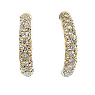 A pair of diamond earrings. Each designed as a brilliant-cut diamond pave-set curved line. Estimated