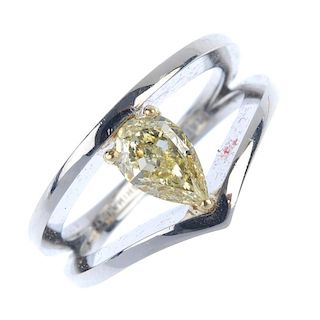 A coloured diamond dress ring. The pear-shape fancy light yellow diamond, weighing 0.76ct, within th