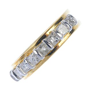 A 9ct gold diamond band ring. Designed as a series of square-shape diamonds, to the ridged band. Est