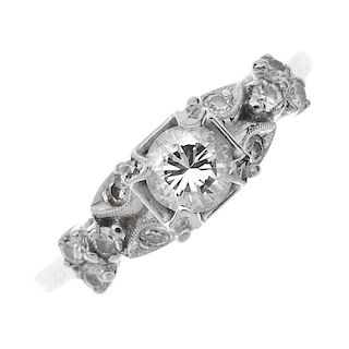 A 14ct gold diamond dress ring. The brilliant-cut diamond, to the single-cut diamond stylised floral