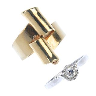 A selection of three 9ct gold rings. To include a brilliant-cut diamond single-stone ring, a scrolli