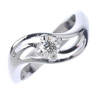 A diamond dress ring. The brilliant-cut diamond, to the openwork asymmetric sides. Estimated diamond