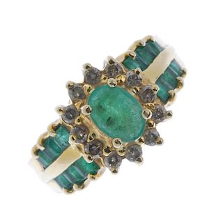 An emerald and diamond ring. The oval-shape emerald, within a brilliant-cut diamond surround, to the