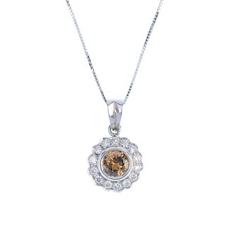 An 18ct gold coloured diamond and diamond cluster pendant. The brilliant-cut 'brown' diamond, within