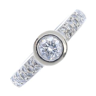 An 18ct gold diamond single-stone ring. The brilliant-cut diamond collet, to the pave-set diamond sh
