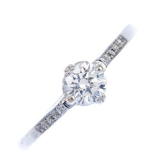 A diamond single-stone ring. The brilliant-cut diamond, to the similarly-cut diamond line sides. Pri