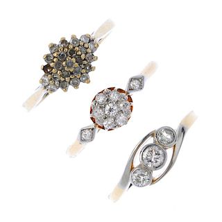 A selection of three diamond dress rings. To include a graduated circular-cut diamond collet three-s