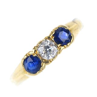 A mid 20th century gold diamond and sapphire three-stone ring. The old-cut diamond, with circular-sh