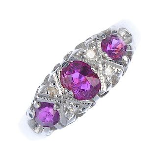 An 18ct gold ruby and diamond ring. The oval and circular-shape ruby line, with single-cut diamond d