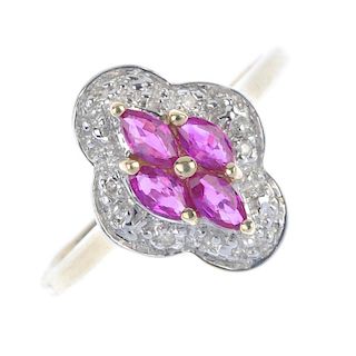 A 9ct gold ruby dress ring. The marquise-shape ruby quatrefoil and bead highlight, within an illusio
