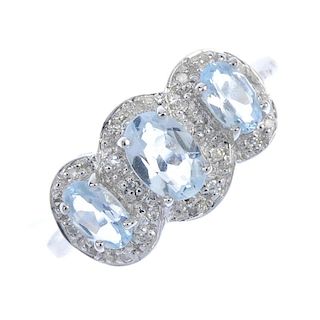 A 9ct gold aquamarine and diamond triple cluster ring. The three graduated oval-shape aquamarines, e