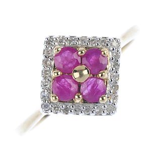 A 9ct gold ruby and diamond dress ring. The circular-shape ruby quatrefoil and bead highlight, withi