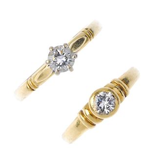 Two diamond rings. The first designed as a brilliant-cut diamond collet with plain bar sides, the se