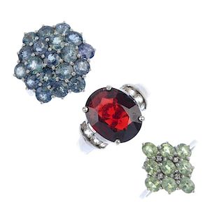 A selection of three 9ct gold gem-set rings. To include a sapphire cluster ring, a garnet and colour