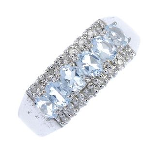 A 9ct gold aquamarine and diamond dress ring. The oval-shape aquamarine line, with single-cut diamon