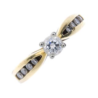 An 18ct gold diamond single-stone ring. The brilliant-cut diamond, with graduated similarly-cut diam