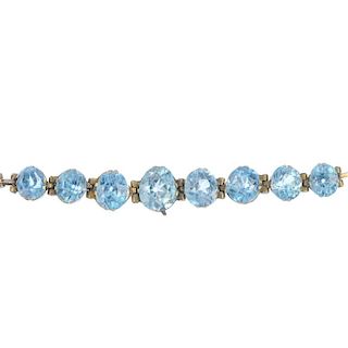 A mid 20th century zircon bracelet. Designed as a series of graduated oval-shape blue zircon, to the