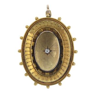 A late Victorian 15ct gold diamond locket. The old-cut diamond star, within an oval panel, to the ca