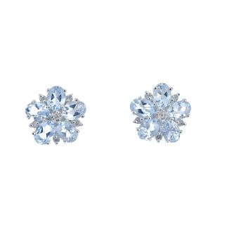 A pair of aquamarine and diamond flower ear studs. Each designed as an oval-shape aquamarine and bri