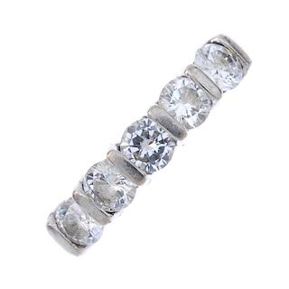 An 18ct gold diamond five-stone ring. The brilliant-cut diamonds, with bar spacers, to the plain ban