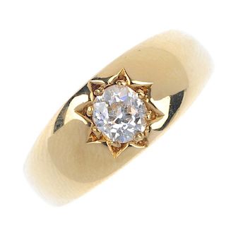 A late Victorian 18ct gold diamond single-stone band ring. The old-cut diamond, to the tapered band.