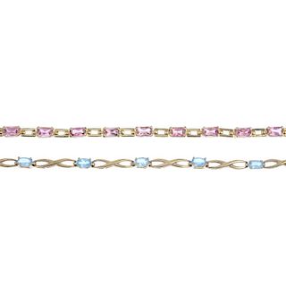 Two 9ct gold topaz bracelets. To include an oval-shape blue topaz and crossover link spacer bracelet