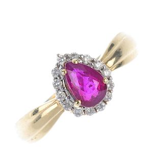 An 18ct gold ruby and diamond cluster ring. The pear-shape ruby, within a brilliant-cut diamond surr