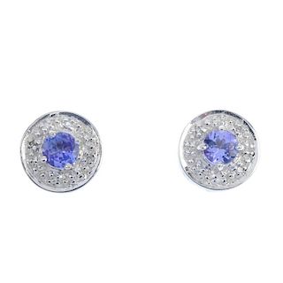 A pair of 9ct gold tanzanite and diamond cluster ear studs. The circular-shape tanzanite, within a s