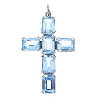 A topaz cross pendant. Designed as across set throughout with rectangular-shape blue topaz. Length 3