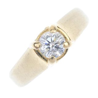 A diamond single-stone ring. The brilliant-cut diamond, within a crossover mount, to the tapered ban