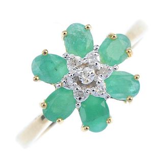 A 9ct gold emerald and diamond floral cluster ring. The single-cut diamond cluster, within an oval-s