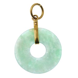 A 1930s 22ct gold band ring and a jade pendant. To include a jadeite bi pendant suspended from a pla