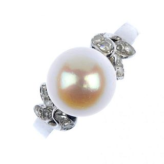 A cultured pearl and diamond dress ring. The cultured pearl measuring approximately 8.15mm, to the s