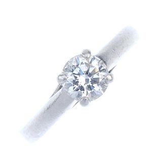 A platinum diamond single-stone ring. The brilliant-cut diamond, to the crossover gallery and plain