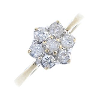 A 9ct gold diamond cluster ring. The brilliant-cut diamond, within a similarly-cut diamond surround,