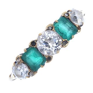 An early 20th century gold emerald and diamond five-stone ring. The graduated old-cut diamonds, with