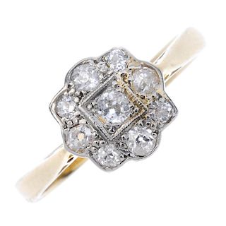 An 18ct gold diamond cluster ring. The old-cut diamond, within a similarly-cut diamond scalloped sur